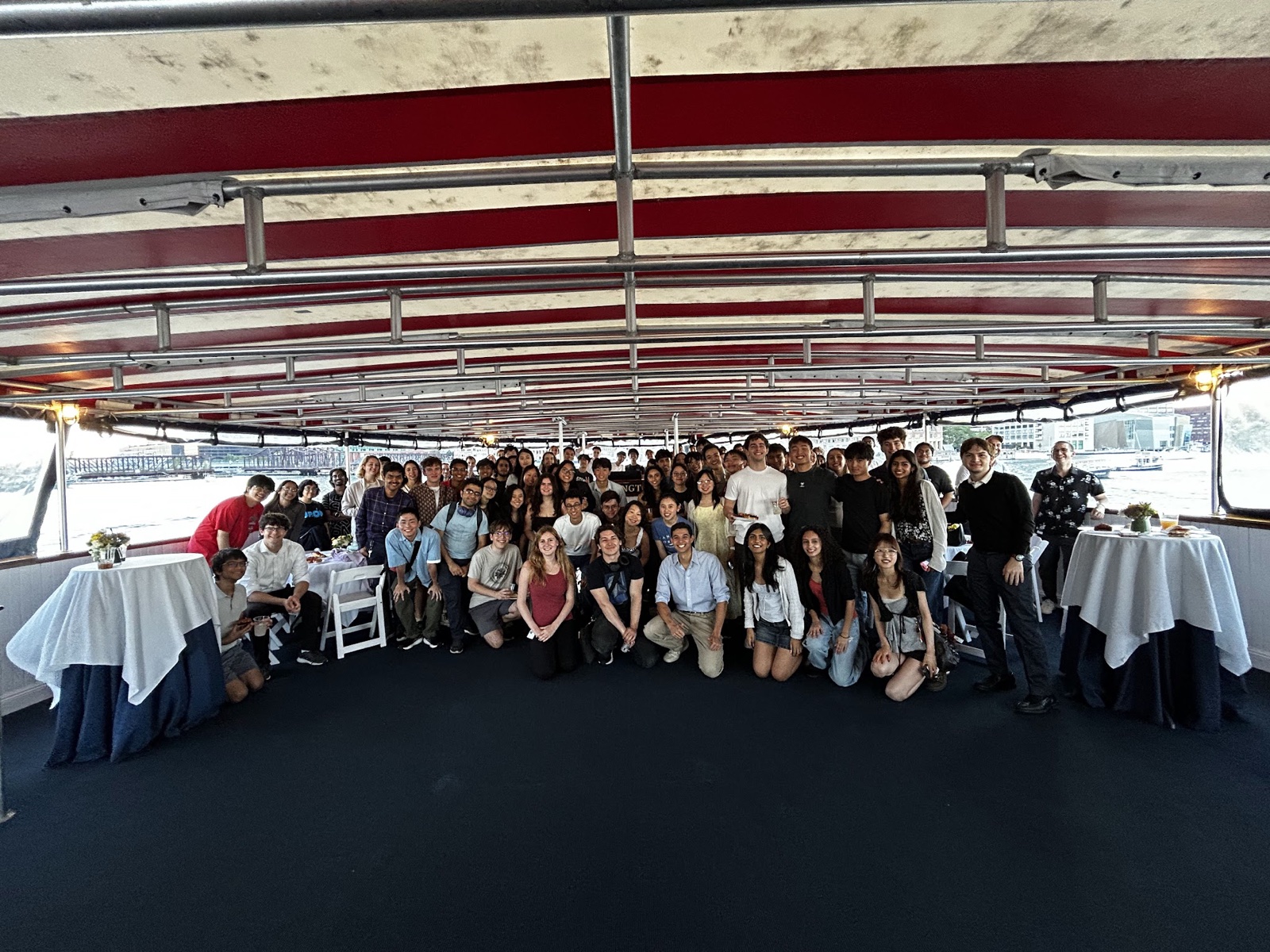 Group photo aboard the MAIA sunset cruise in Boston Harbor, September 2026