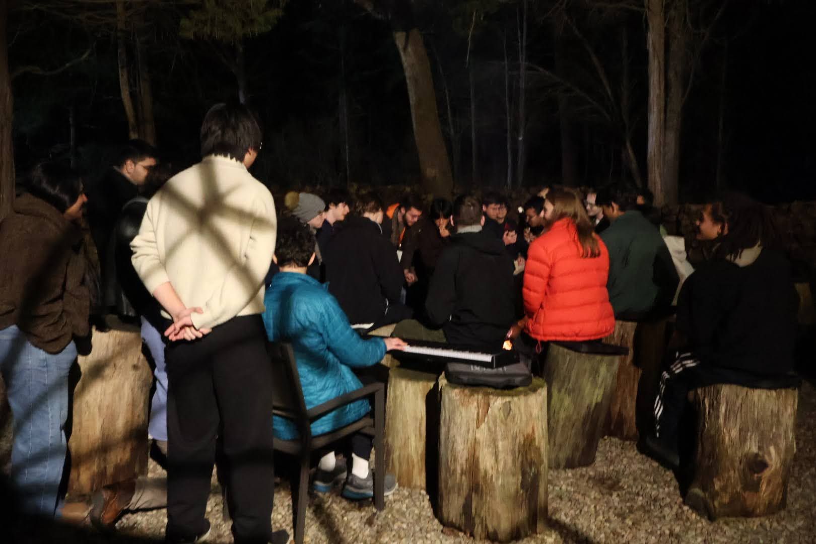 Students gathered around a campfire